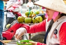 Vietnamese women street vendors wearing conical hats