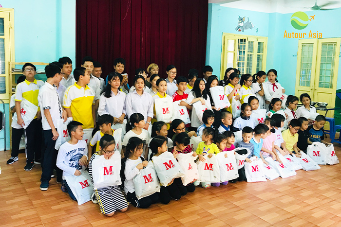 Mr Millet Claude and Mme Monique give gifts to children