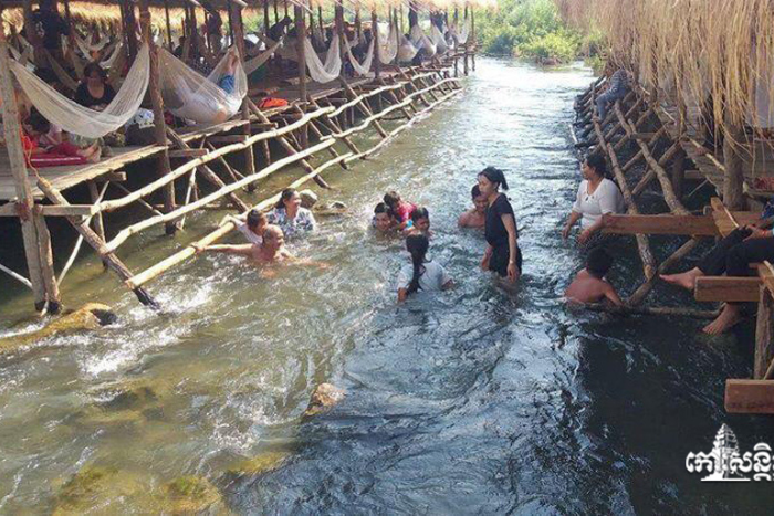 Tourists bathe in the river at Kampi rapids, Kratie