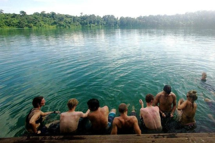 Tourists immersing themselves in the clear blue waters of Yeak Laom Lake