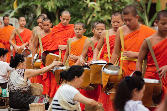 Experience the Alms-Giving Ceremony: A serene moment of spirituality in your Luang Prabang itinerary 3 days.