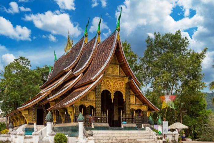 Experience the beauty of Luang Prabang’s iconic temple during the rain in Laos.