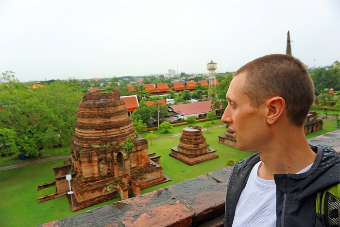 Tourist visits Wat Yai Chai Mongkol during rainy season