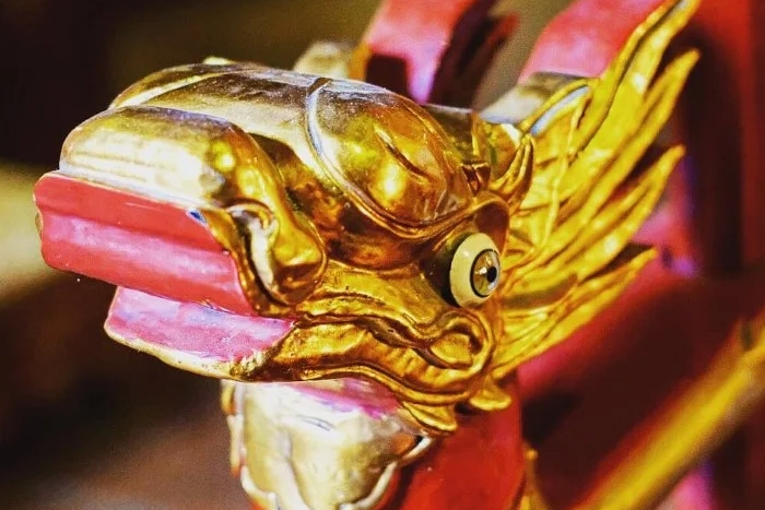 The traditional dragon pattern on red-lacquered funeral palanquins