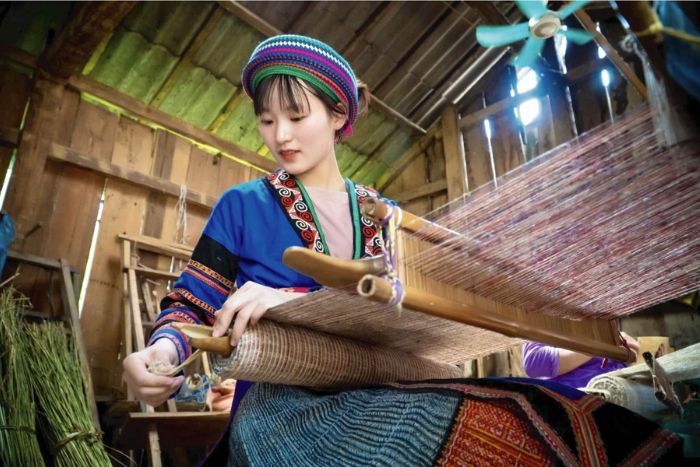 Hmong women sew handmade items