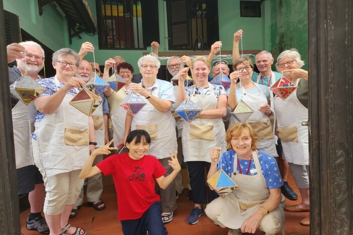 Tourists learn to make lanterns as souvenir in Reaching Out Arts & Crafts