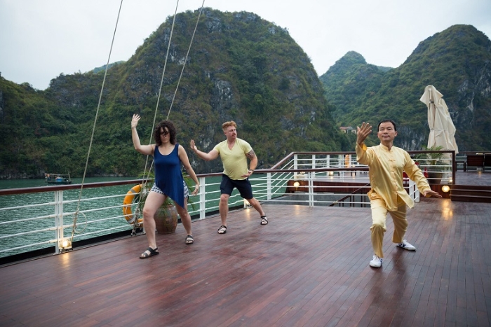 Taking a Tai Chi in Halong cruise in morrning